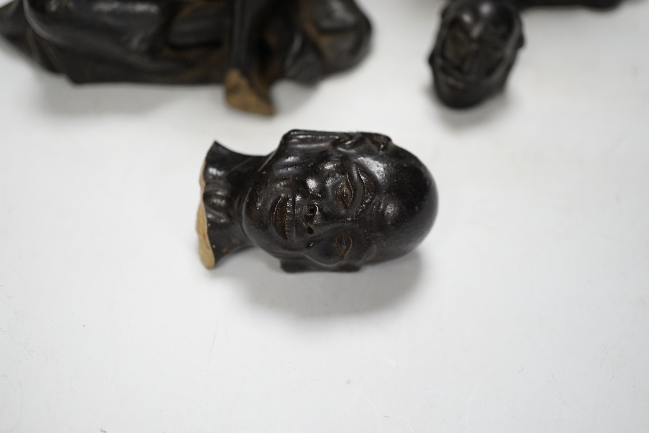 Two Chinese pottery figures of luohan, damaged, 15.5cm